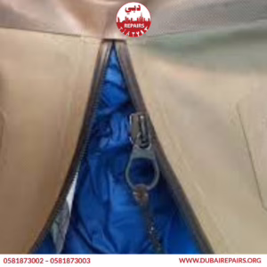 Technician reinforcing duffel bag straps in Dubai workshop