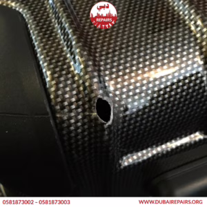 Damaged hard case suitcase before professional repair at Dubai Repairs